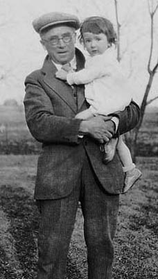 photo of Jackie, around 2 years old, with Grampa